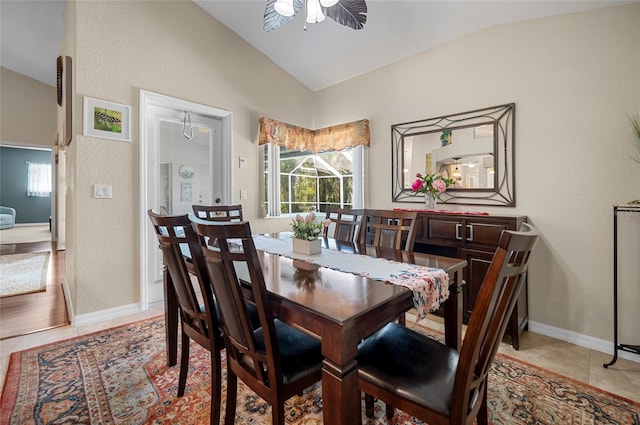 tiled dining space with lofted ceiling and ceiling fan