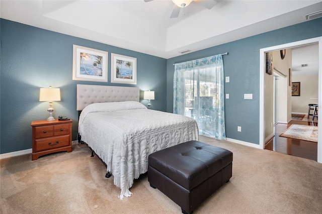 bedroom with a tray ceiling, access to outside, ceiling fan, and carpet