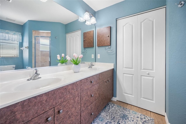 bathroom featuring vanity, wood-type flooring, toilet, and walk in shower