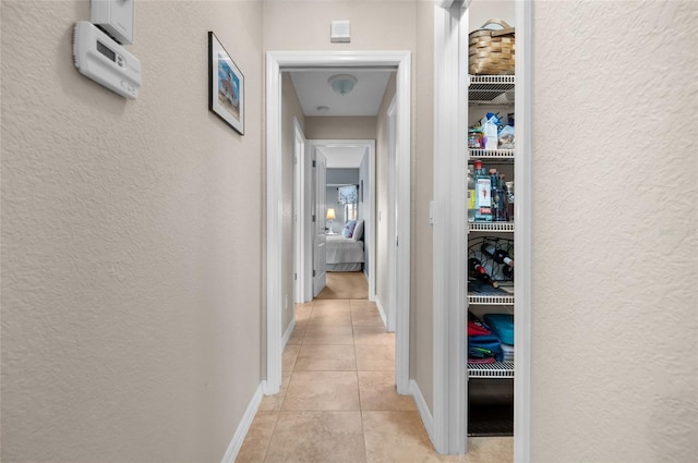 hall featuring light tile patterned flooring