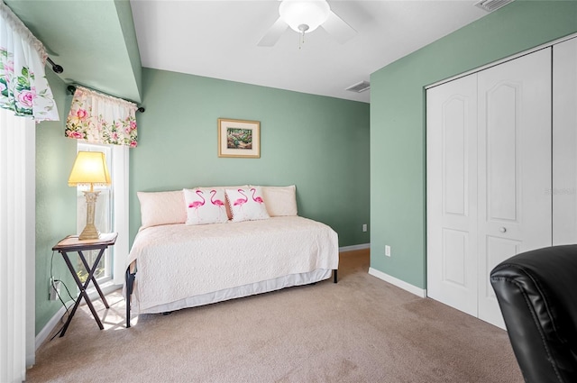 bedroom with a closet, ceiling fan, and carpet