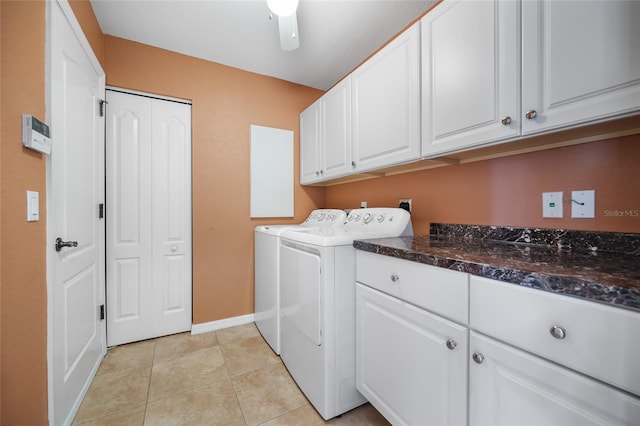 laundry room with ceiling fan, cabinets, washing machine and dryer, and light tile patterned floors