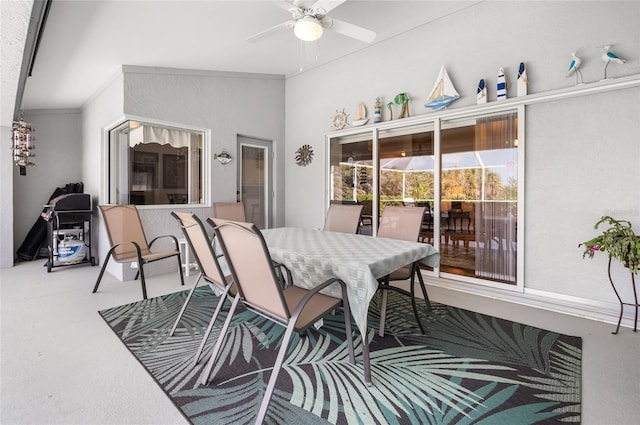 dining space with crown molding, ceiling fan, and carpet flooring