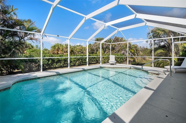 view of swimming pool featuring a patio and glass enclosure