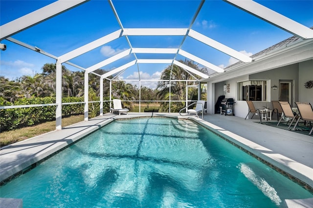 view of swimming pool featuring a lanai and a patio