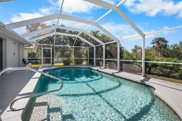 view of pool with a patio and glass enclosure