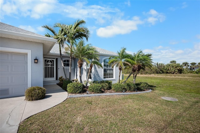 exterior space featuring a garage and a front yard