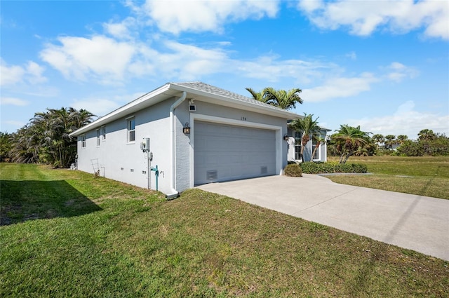 view of side of property featuring a garage and a lawn