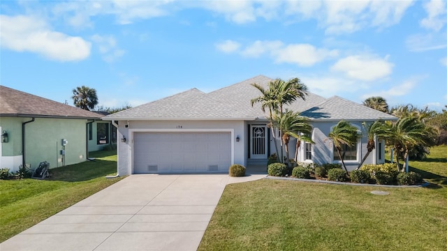 ranch-style house featuring a garage and a front lawn