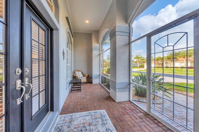 unfurnished sunroom with french doors