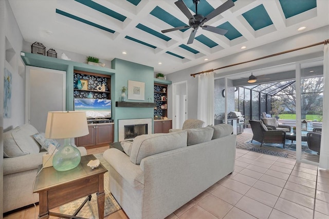 living room with coffered ceiling, light tile patterned floors, beamed ceiling, and ceiling fan