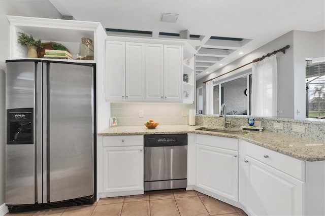 kitchen featuring white cabinetry, sink, decorative backsplash, light stone counters, and stainless steel appliances