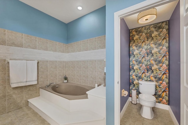 bathroom with tile patterned flooring, a bathing tub, and toilet