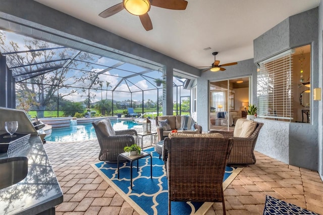 view of patio / terrace with a swimming pool with hot tub, outdoor lounge area, and a lanai