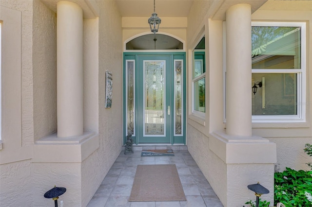 entrance to property featuring stucco siding