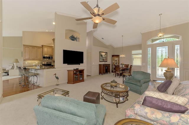 living area with high vaulted ceiling, carpet, crown molding, and ceiling fan