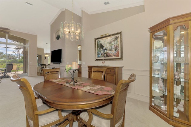 dining area with visible vents, a chandelier, a decorative wall, and light colored carpet