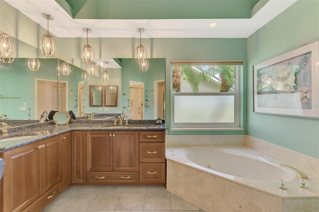 bathroom featuring double vanity, a jetted tub, a sink, and tile patterned floors