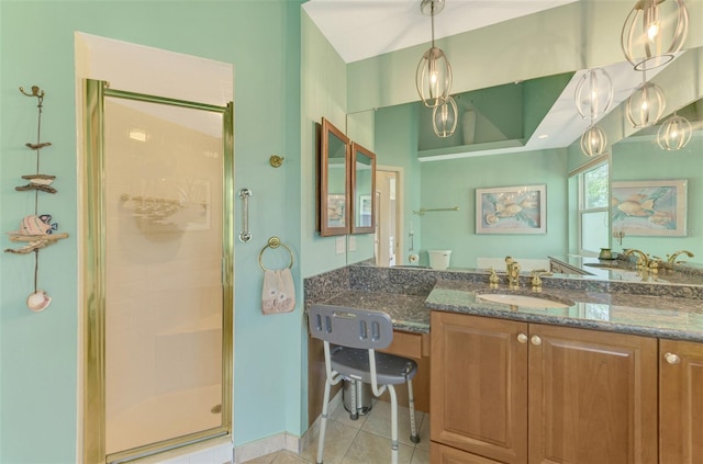 full bath featuring a stall shower, vanity, and tile patterned floors