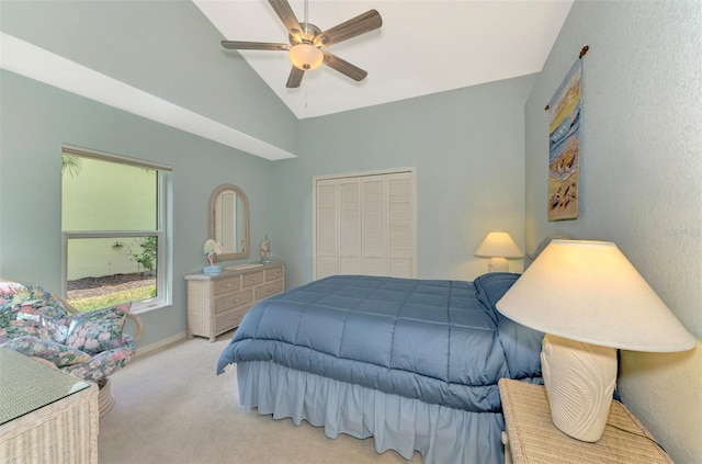 bedroom featuring lofted ceiling, carpet flooring, a ceiling fan, baseboards, and a closet