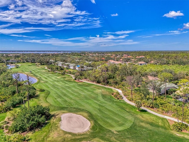 birds eye view of property with golf course view and a wooded view