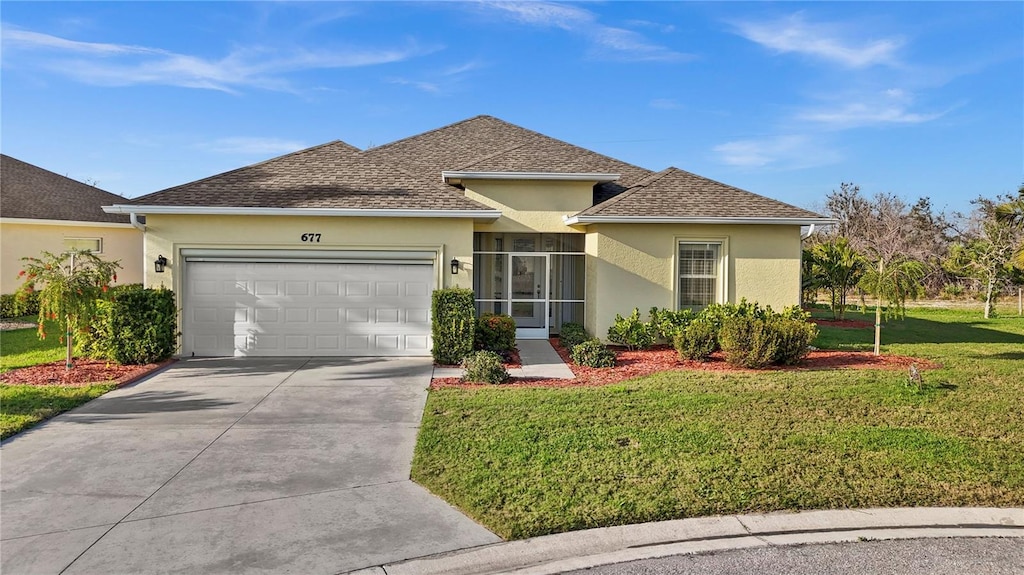 view of front of house with a garage and a front lawn