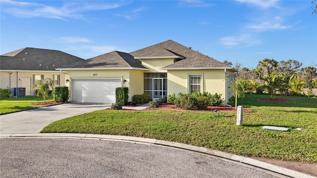 view of front of property featuring a garage, a front yard, and cooling unit