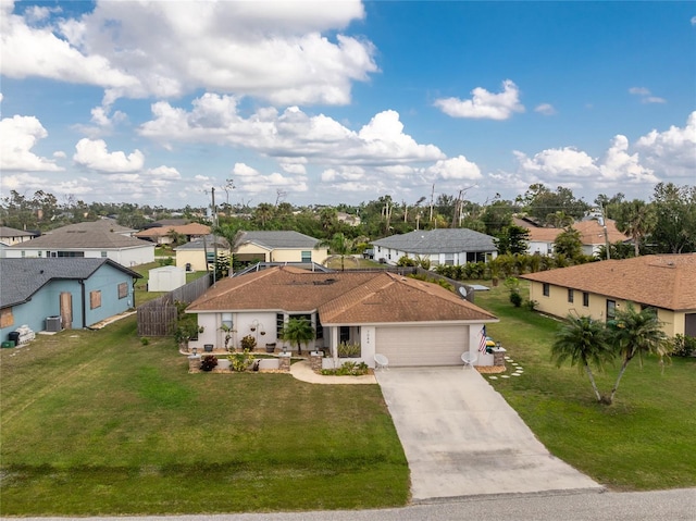 single story home featuring a garage and a front lawn