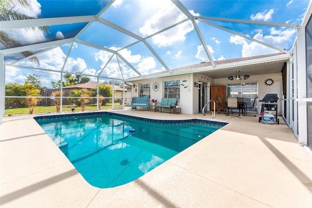 view of pool featuring a patio area, ceiling fan, and glass enclosure