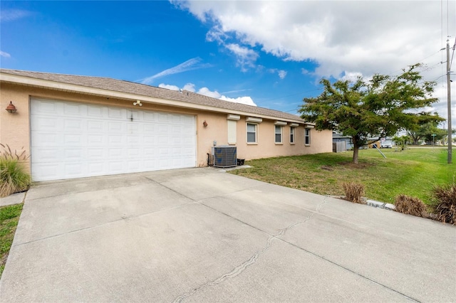 ranch-style home with a front yard, a garage, and cooling unit