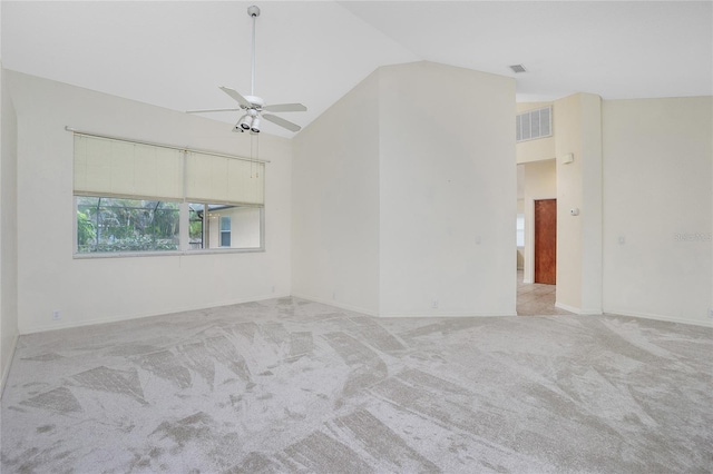 carpeted spare room with ceiling fan and high vaulted ceiling