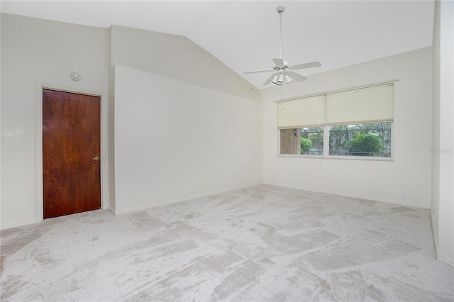 carpeted spare room with ceiling fan and lofted ceiling