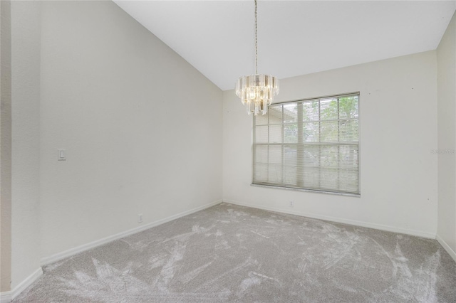 unfurnished room with a notable chandelier, carpet flooring, and lofted ceiling