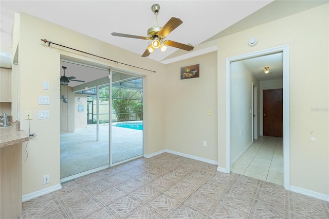 tiled spare room with sink, lofted ceiling, and ceiling fan