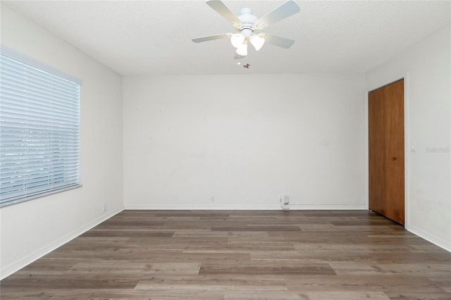 spare room with ceiling fan, a textured ceiling, and hardwood / wood-style floors