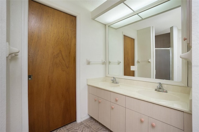 bathroom with vanity and a shower with shower door