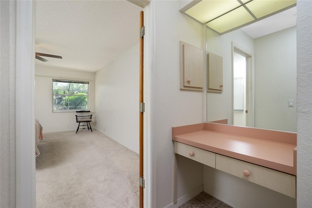 bathroom featuring a textured ceiling, vanity, and ceiling fan