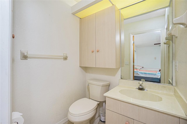 bathroom with toilet and vanity