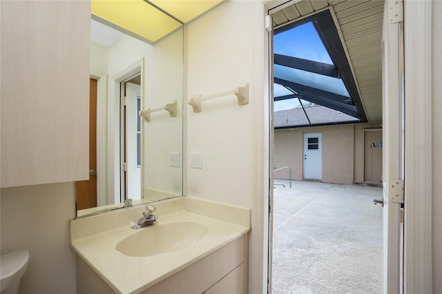 bathroom featuring toilet and vanity