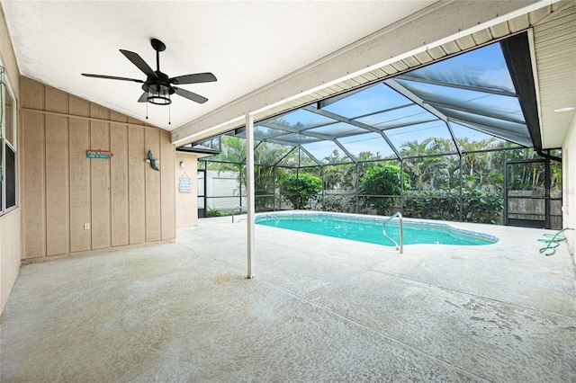 view of pool with a patio and glass enclosure