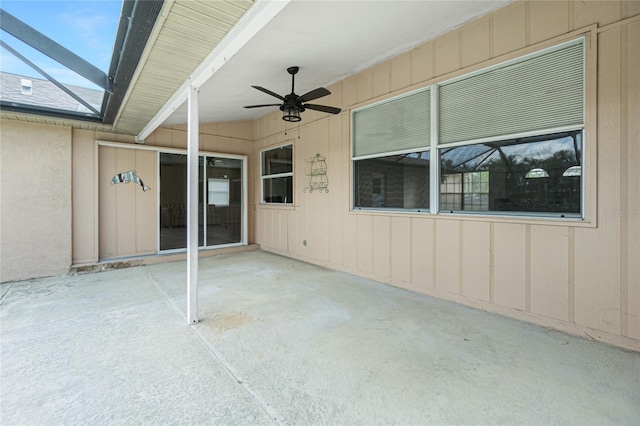 view of patio with ceiling fan and a lanai