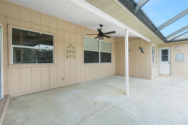 view of patio with ceiling fan and a lanai