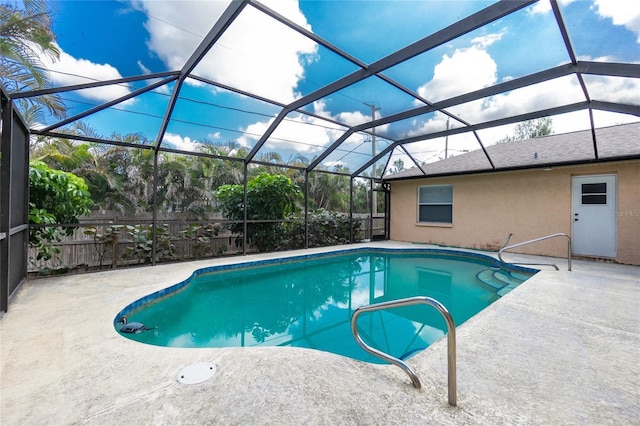 view of pool featuring a patio area and glass enclosure