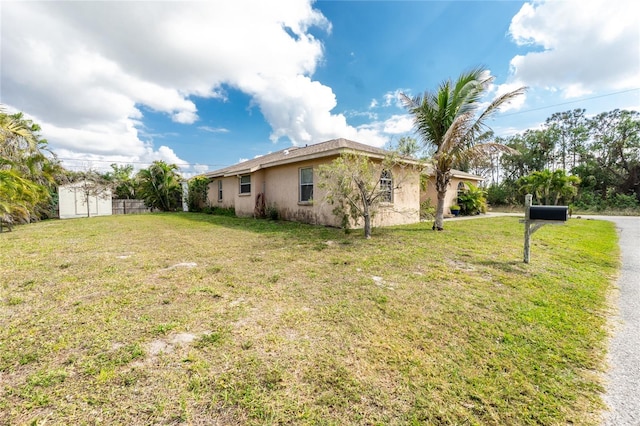 view of side of property with a yard