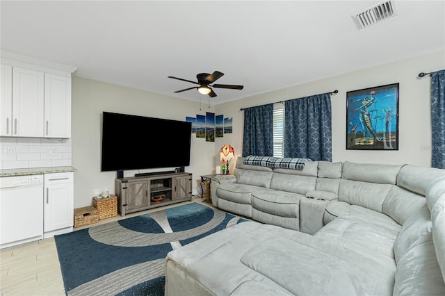 living room with ceiling fan and light hardwood / wood-style flooring