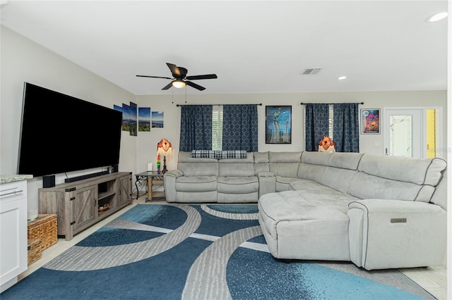 living room featuring a healthy amount of sunlight and ceiling fan