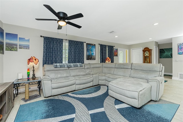 living room with light wood-type flooring and ceiling fan