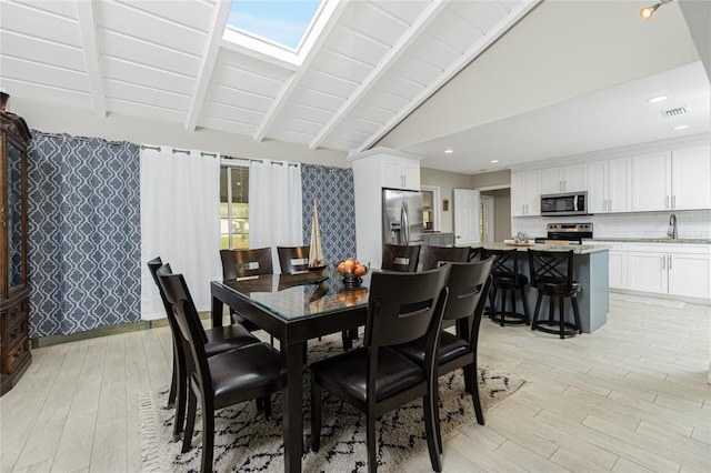 dining area featuring light hardwood / wood-style floors, vaulted ceiling with beams, and wooden ceiling