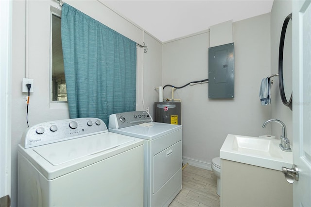 laundry area with electric panel, sink, separate washer and dryer, and water heater