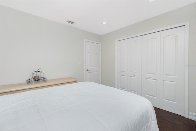 bedroom with a closet and dark hardwood / wood-style flooring